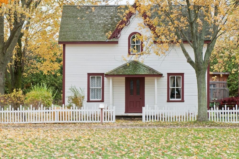 A white house under maple trees