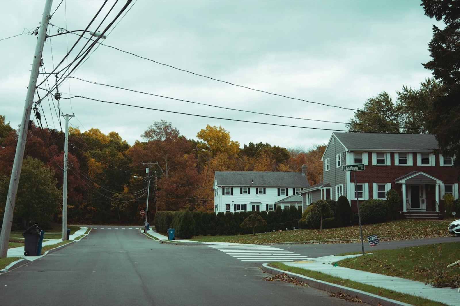 A quiet Westchester street of colonial houses in autumn