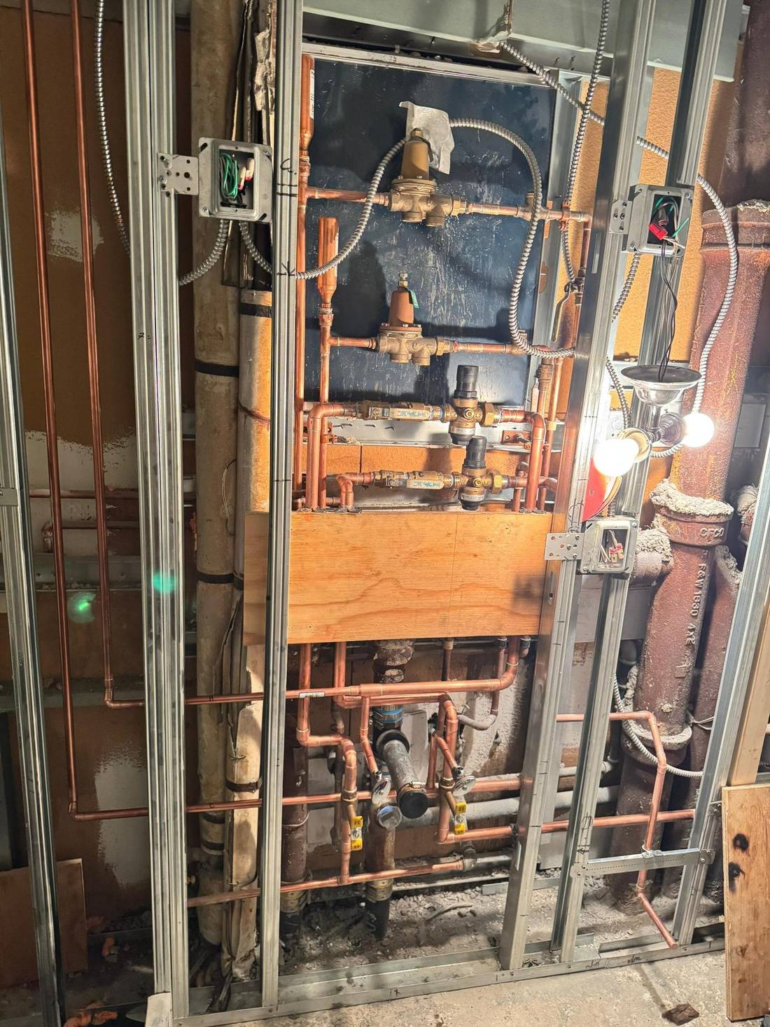 Pressure reducing valves, backflow preventers and copper risers where the water service comes in